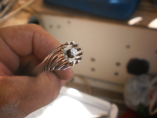 Wrap the outside wires back around the core and the cone. One wire should end up in each groove in the crown.  This is probably the hardest part and it's not particularly hard at all.